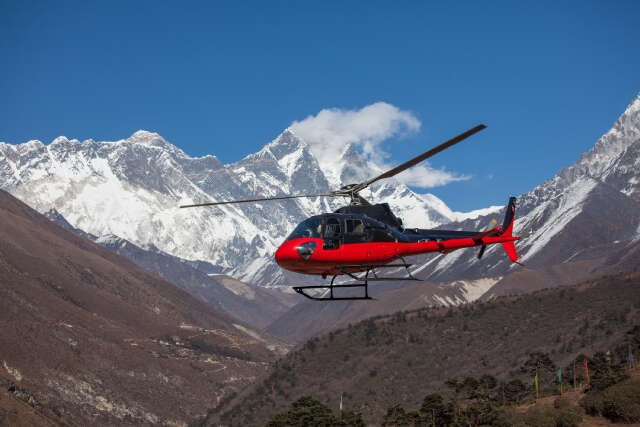 Helicopter Flying Over Snow-capped Himalayan Mountains
