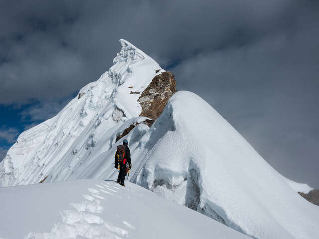 Mountaineer Standing On Snowy Ridge Near The Lobuche Peak