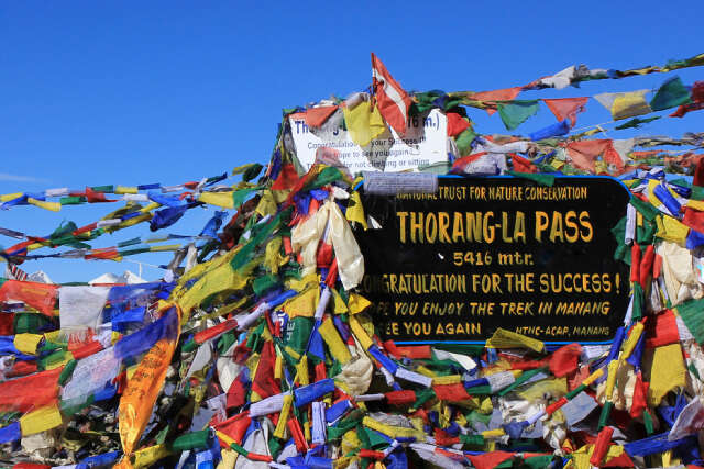 Prayer Flags And Signboard On The Thorang La Mountain Pass