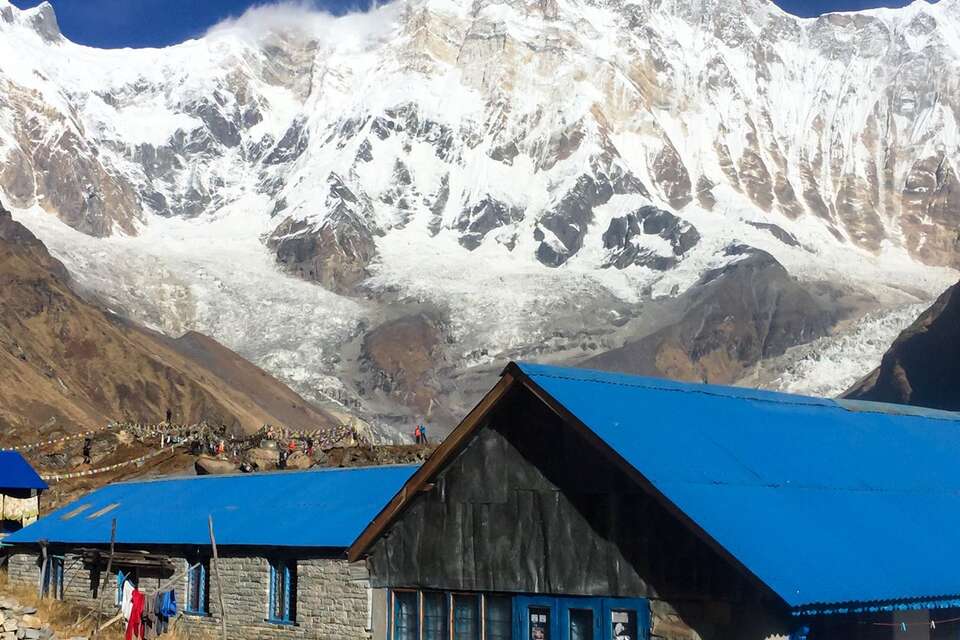 Tea houses with Annapurna in the background on the Annapurna Base Camp trek