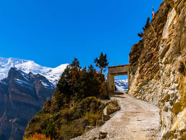 Trail By The Snowy Himalayan Mountains On The Annapurna Circuit Trek